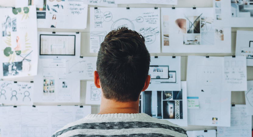 Person Looking at Pin Board Person Looking at Pin Board